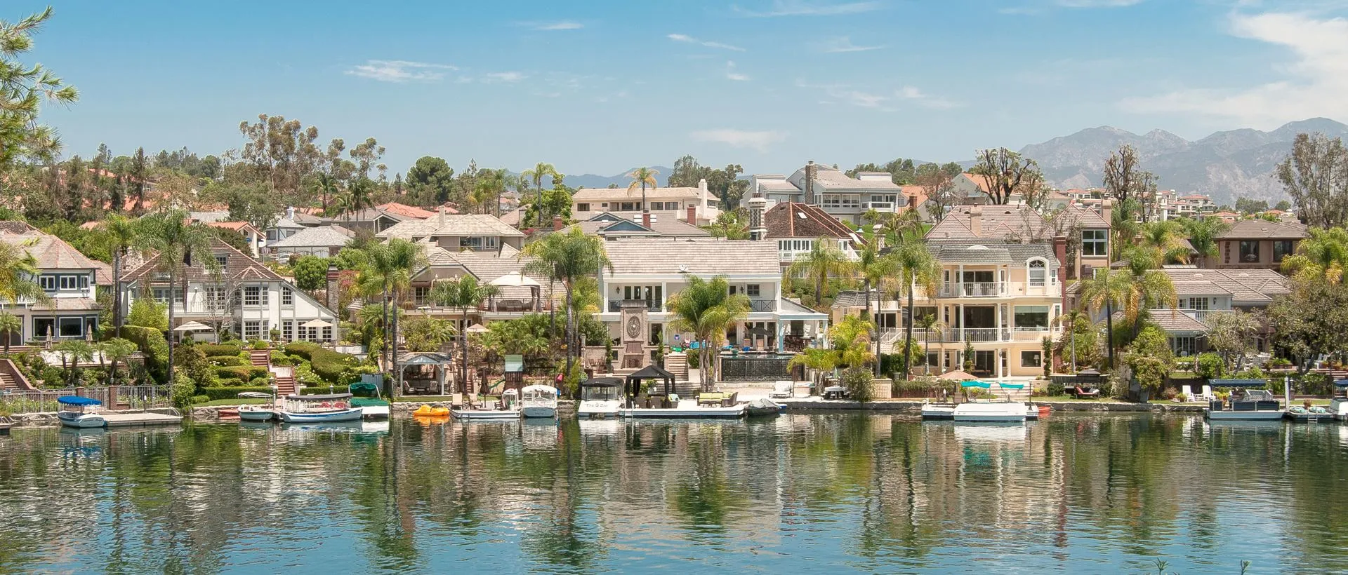 View of luxury homes at Lake Mission Viejo, California, landscaped yards.