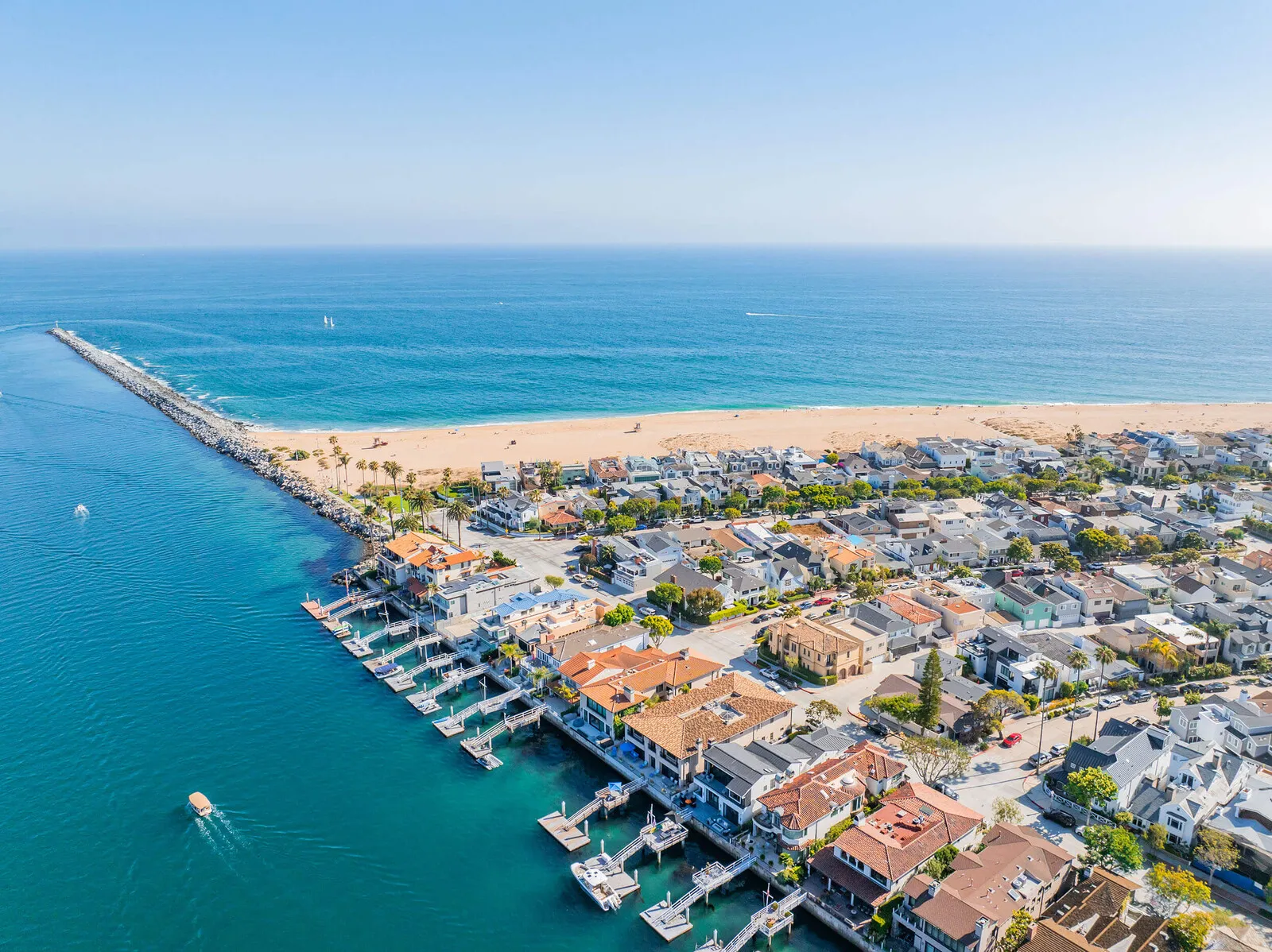 Aerial view of Newport Beach, California, showing luxury waterfront homes, private docks.